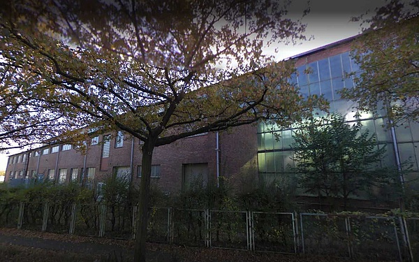 aixit's datacenter building in Hamburg, hidden behind trees